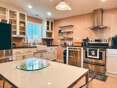 a large kitchen with a white table and appliances at Modern SD Oasis with Pool & HotTub in San Diego