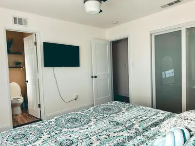 a bedroom with a bed and a flat screen tv at Modern SD Oasis with Pool & HotTub in San Diego