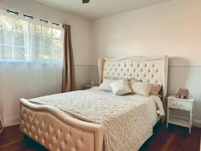 a bedroom with a large bed with a large window at Modern SD Oasis with Pool & HotTub in San Diego