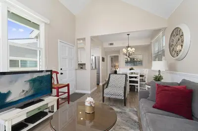 a living room with a couch and a tv at 6Br Oceanview Getaway Steps From 27Th St Beach By Beachview Rentals in Newport Beach