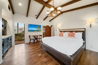 a bedroom with a bed and a kitchen with a table at Oceanview Rooftop Escape Modern Spanish Decor in San Diego