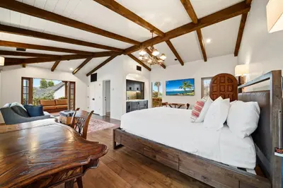 a bedroom with a large bed and a dining room at Oceanview Rooftop Escape Modern Spanish Decor in San Diego