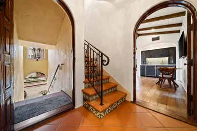an archway leading to aoyer with a staircase in a house at Oceanview Rooftop Escape Modern Spanish Decor in San Diego