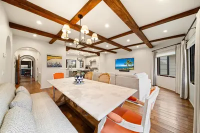 a dining room and living room with a table and chairs at Oceanview Rooftop Escape Modern Spanish Decor in San Diego