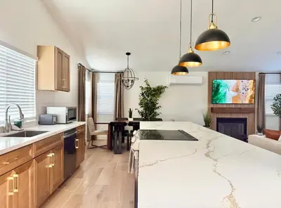 a kitchen with a large white counter top and wooden cabinets at Designer's Touch in San Diego