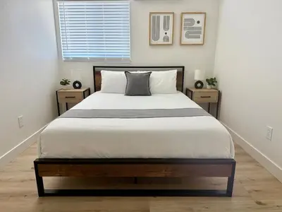 a bedroom with a large bed with two night stands at Designer's Touch in San Diego