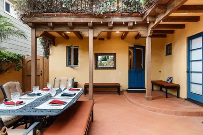 a patio with a table and chairs and a pergola at Majestic Corner Coastal Haven in San Diego