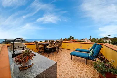 a balcony with chairs and a table on a roof at Majestic Corner Coastal Haven in San Diego