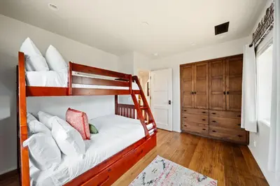 a bedroom with two bunk beds and a closet at Majestic Corner Coastal Haven in San Diego
