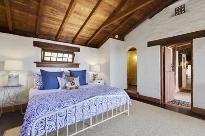 a bedroom with a bed with a blue comforter at North County Oasis in Vista
