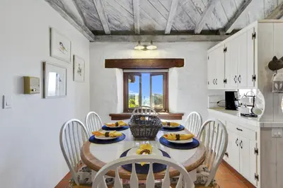 a kitchen and dining room with a table and chairs at North County Oasis in Vista