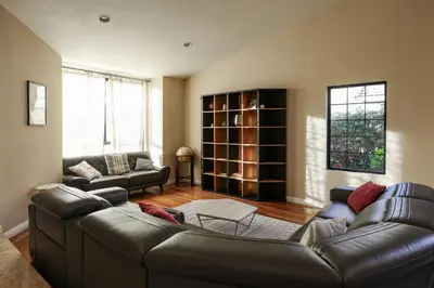 a living room with a leather couch and a table at Hilltop Escape in Carmel Valley in San Diego