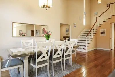 a dining room with a table and chairs and a mirror at Hilltop Escape in Carmel Valley in San Diego