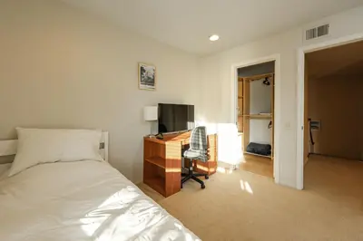 a bedroom with a bed and a desk with a computer at Hilltop Escape in Carmel Valley in San Diego