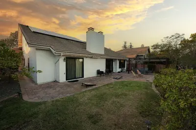 a white house with a patio and a yard at Hilltop Escape in Carmel Valley in San Diego