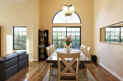 a dining room with a table with chairs and a couch at Hilltop Escape in Carmel Valley in San Diego