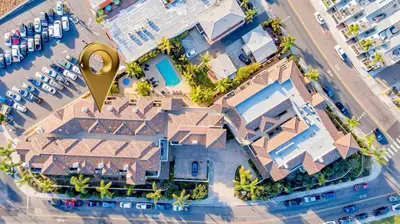 an overhead view of a resort with a large yellow magnifying glass at Beach - Walk - Village - Pool - Spa - Gym - Resort in Carlsbad