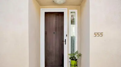 a door to a house with a sign on it at Beach - Walk - Village - Pool - Spa - Gym - Resort in Carlsbad