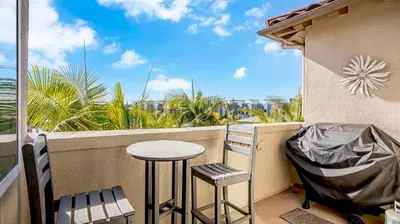 a balcony with a table and two chairs and a view at Beach - Walk - Village - Pool - Spa - Gym - Resort in Carlsbad