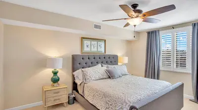 a bedroom with a bed and a ceiling fan at Beach - Walk - Village - Pool - Spa - Gym - Resort in Carlsbad