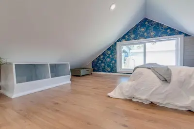 a bedroom with a bed and a large window at Comfy Bay Park Cottage close to Everything! in San Diego