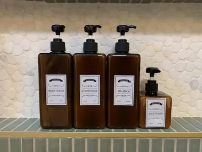 three bottles of soap are sitting on a shelf at NEW! Hot TubPoolFire Pit10 Mins to Beach in San Diego
