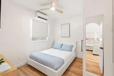 a bedroom with a bed and a ceiling fan at La Jolla Villa by the Sea - Walk to Windansea in San Diego