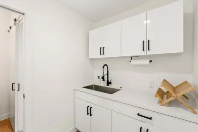 a white kitchen with white cabinets and a sink at La Jolla Villa by the Sea - Walk to Windansea in San Diego