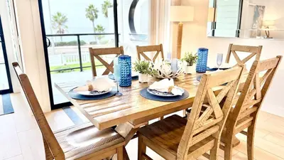 a wooden table with chairs and a dining room at Location! Location! Location! Walk Everywhere! in Oceanside