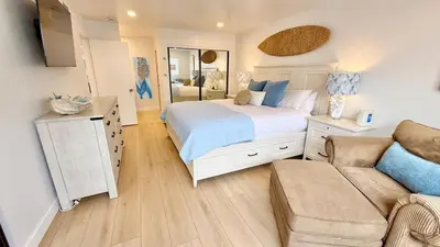 a bedroom with a large bed and a couch at Location! Location! Location! Walk Everywhere! in Oceanside