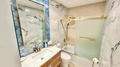 a bathroom with a sink and a toilet and a mirror at Location! Location! Location! Walk Everywhere! in Oceanside