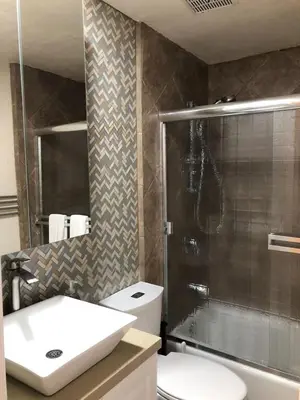 a bathroom with a shower and a toilet and a sink at Ocean Front On Beach! -2 Master BR, 2 Full BA, Patio!, AC, Parking, Close to All in San Diego