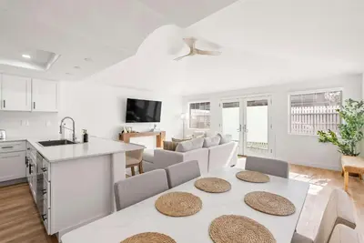 a kitchen and living room with a table and chairs at Luxury La Jolla Beach Retreat - Steps to Windansea in San Diego