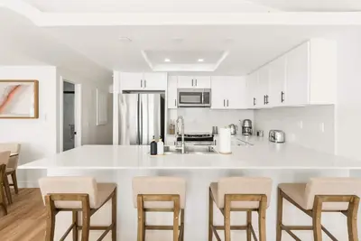 a kitchen with white cabinets and a white counter top at Luxury La Jolla Beach Retreat - Steps to Windansea in San Diego