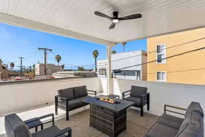 a patio with chairs and a table on a roof at Luxury La Jolla Beach Retreat - Steps to Windansea in San Diego
