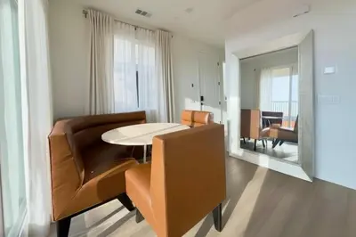 a living room with a table and chairs and a mirror at 4 Bed Large House in San Diego Amazing Amenities in Chula Vista