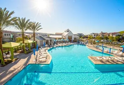 a large swimming pool with chairs and palm trees at 4 Bed Large House in San Diego Amazing Amenities in Chula Vista