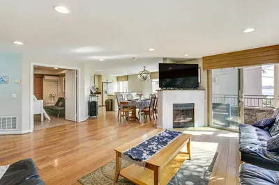 a living room with a couch and a fireplace at Walk to Mission Beach! Gem with Bay and City Views in San Diego
