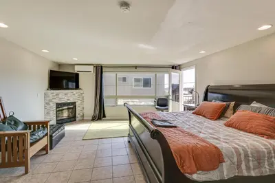 a bedroom with a bed and a fireplace at Walk to Mission Beach! Gem with Bay and City Views in San Diego