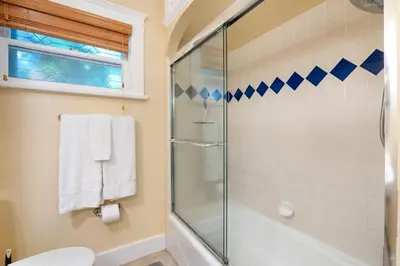 a bathroom with a glass shower and a toilet at La Jolla Village Escape - Walk to Everything in San Diego