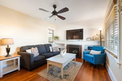 a living room with a couch and a fireplace at La Jolla Village Escape - Walk to Everything in San Diego