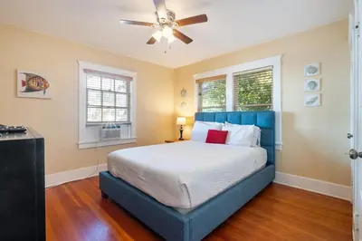 a bedroom with a blue bed and a ceiling fan at La Jolla Village Escape - Walk to Everything in San Diego