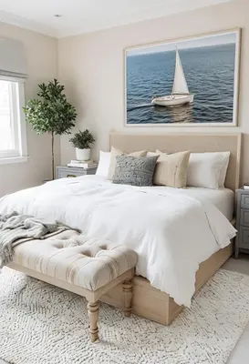 a bedroom with a large bed with a sailboat in the water at Newport Beach Oceanside Stay in Newport Beach