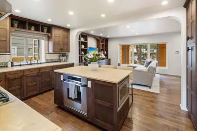 a kitchen with wooden cabinets and a counter top at Lush by the Sea in San Diego