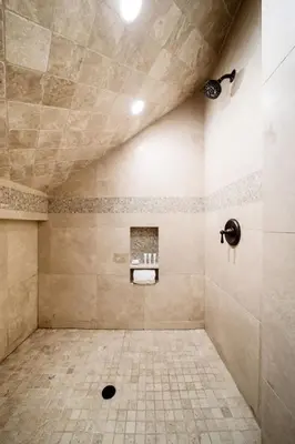 a bathroom with a shower with a tiled floor at Lush by the Sea in San Diego