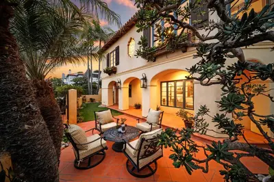 a patio with chairs and a table in front of a house at Lush by the Sea in San Diego