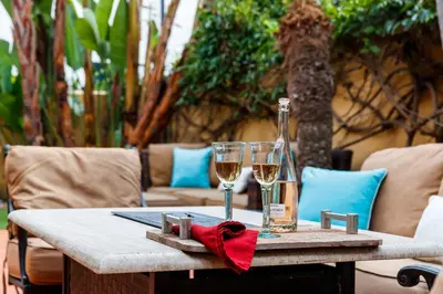 a table with two glasses and a bottle of wine at Lush by the Sea in San Diego