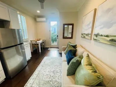 a living room with a couch and a refrigerator at Newly Built Coastal Southern California Getaway in Carlsbad