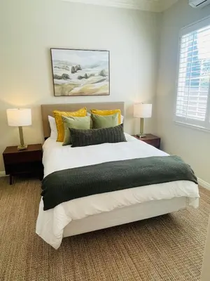 a bedroom with a large bed with two lamps at Newly Built Coastal Southern California Getaway in Carlsbad