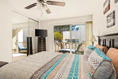 a bedroom with a bed with a ceiling fan at Bayfront Bliss in San Diego